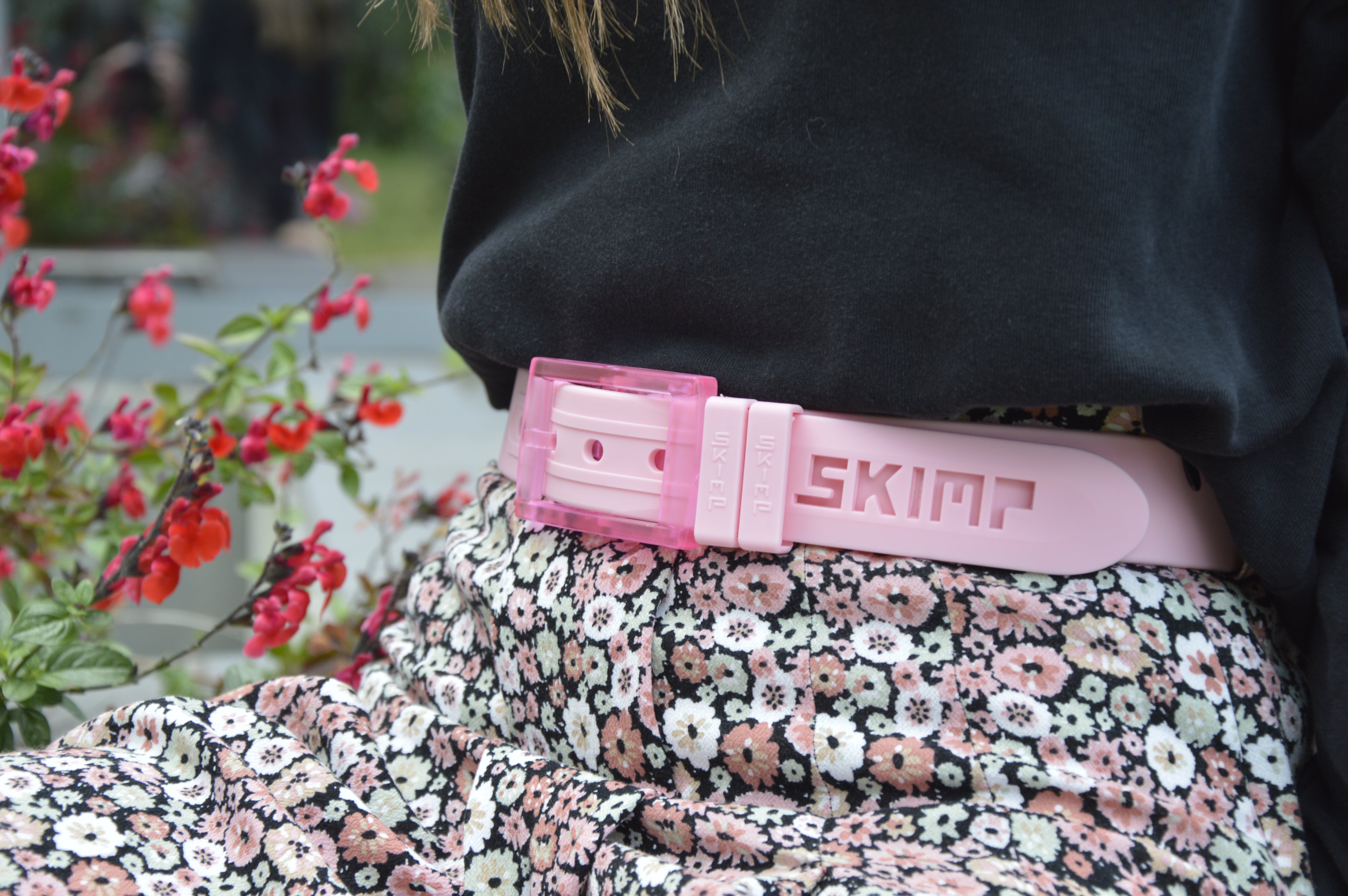 Light pink SKIMP Originale belt worn with a floral skirt