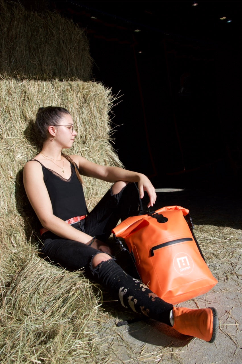 Orange SKIMP Adventurer backpack at the yard