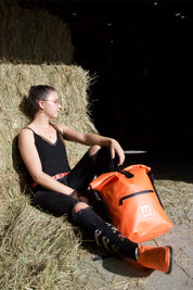 Orange SKIMP Adventurer backpack at the yard