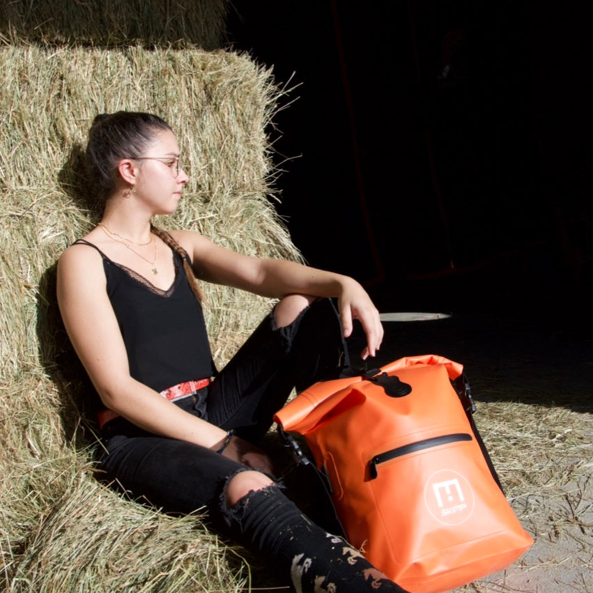Orange SKIMP Adventurer backpack at the yard