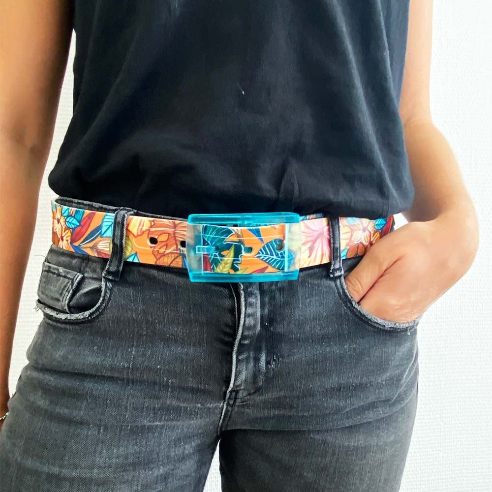 SKIMP Petite Lulu Tropical Belt with turquoise buckle worn with grey jeans