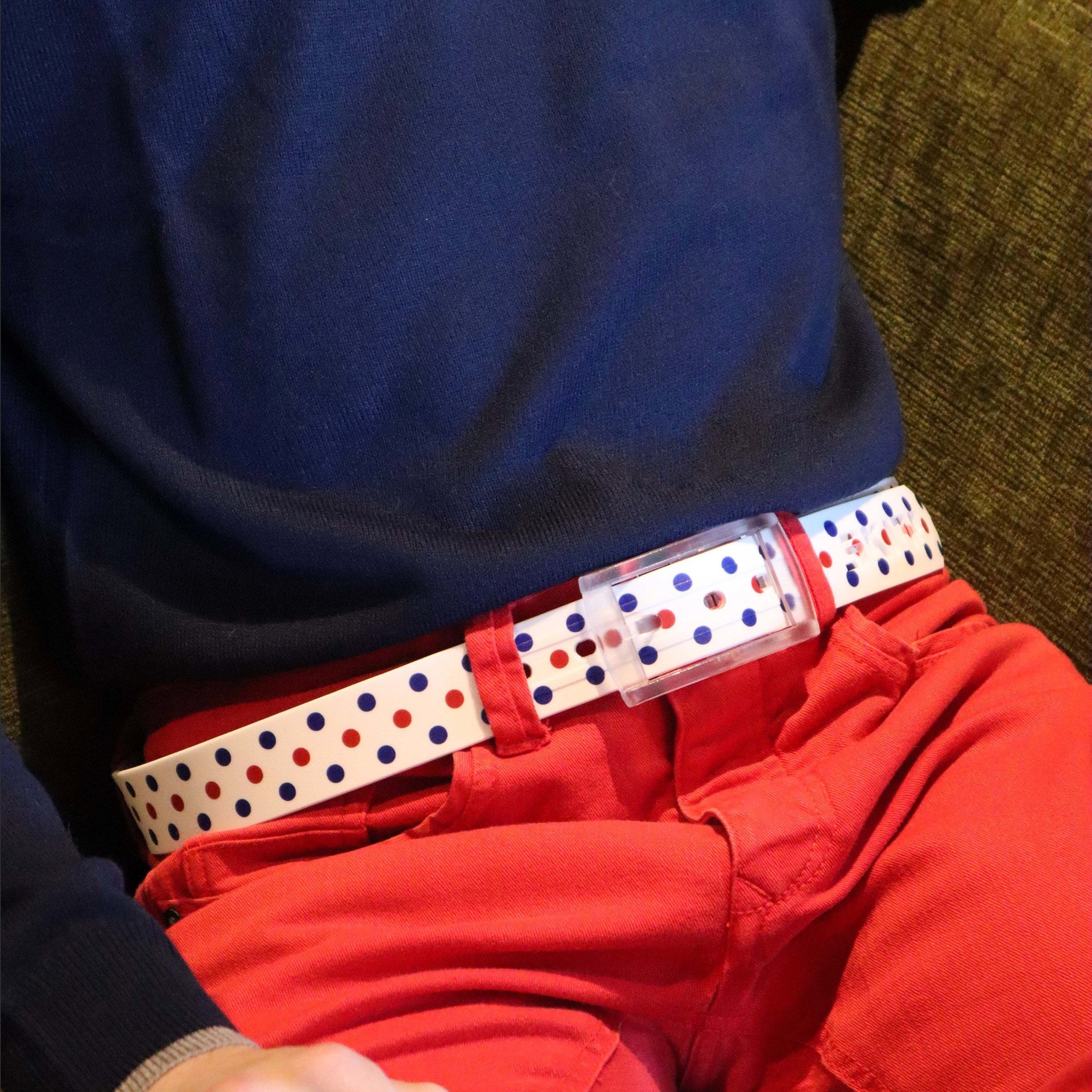 SKIMP Regatta Dot Belt worn with red trousers and navy jumper – white belt with red and blue polka dots