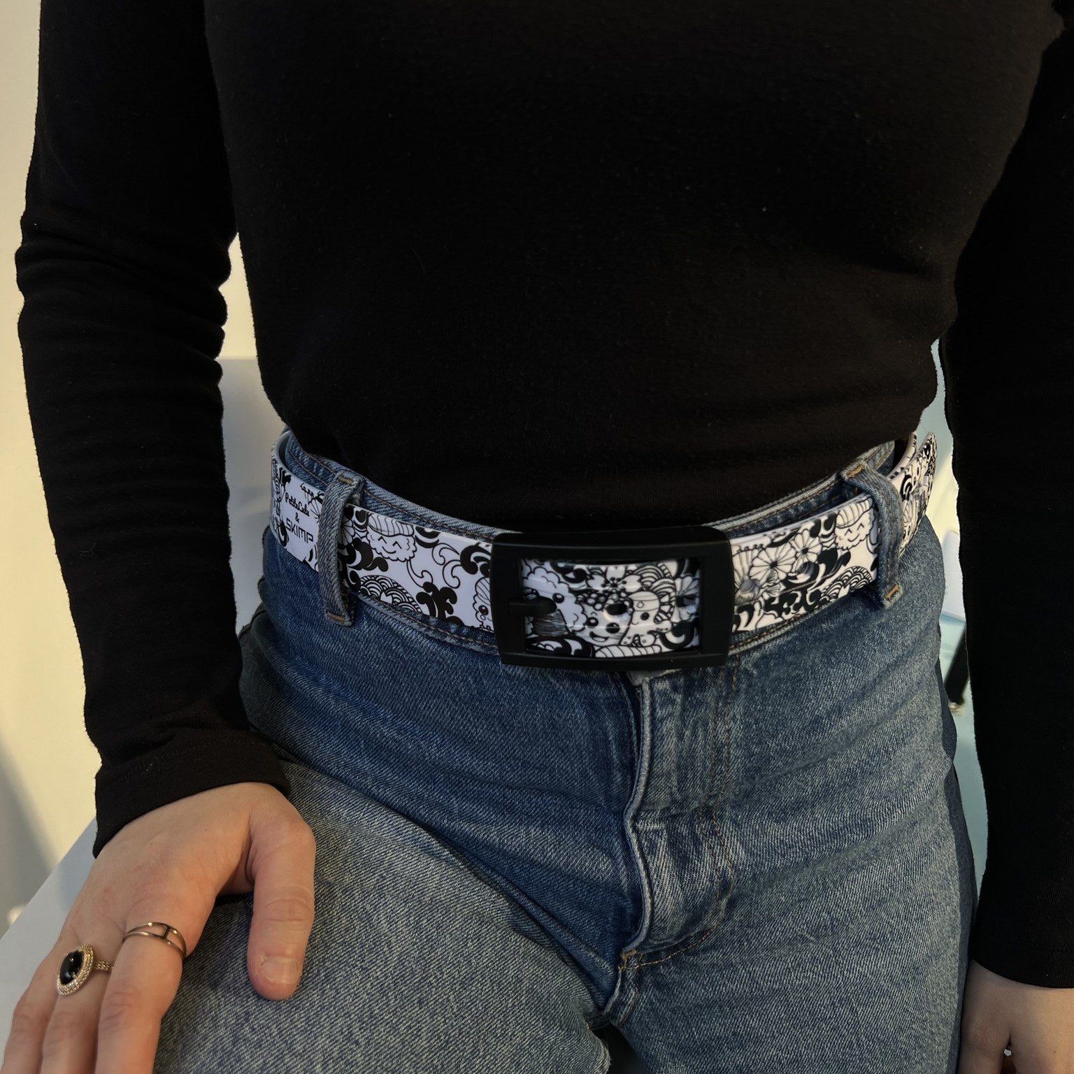 SKIMP black and white sushi print belt worn with blue jeans and a black top