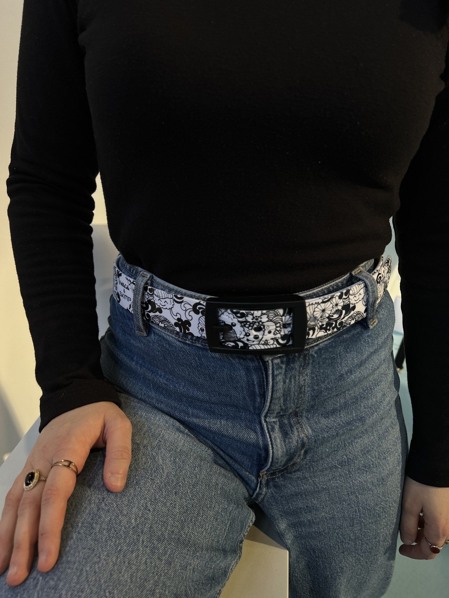 SKIMP black and white sushi print belt worn with blue jeans and a black top
